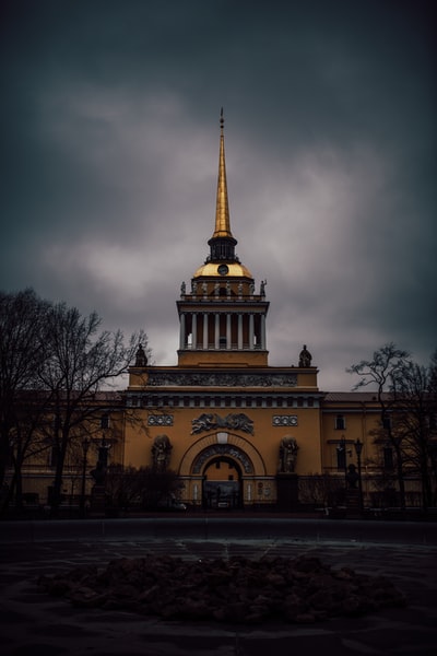 Under the gray clouds of brown concrete building
